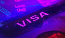 Close-up of a visa page under UV light—hero image for a Cyprus immigration guide covering visas, residence and work permits in 2025.